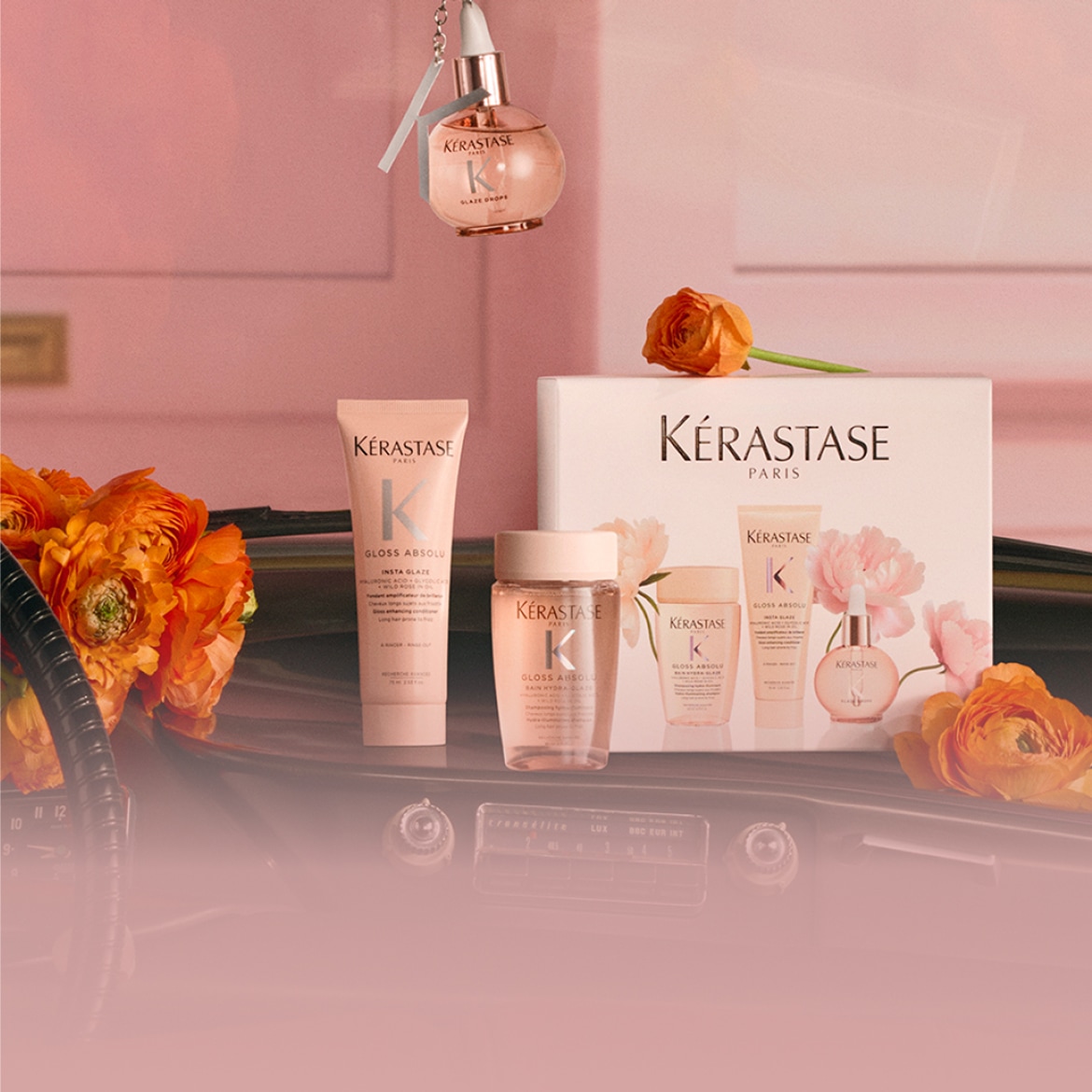 Découvrez le coffret Kérastase Gloss Absolu, comprenant un shampooing, un soin et un sérum pour des cheveux brillants et éclatants, le tout dans un emballage rose élégant.