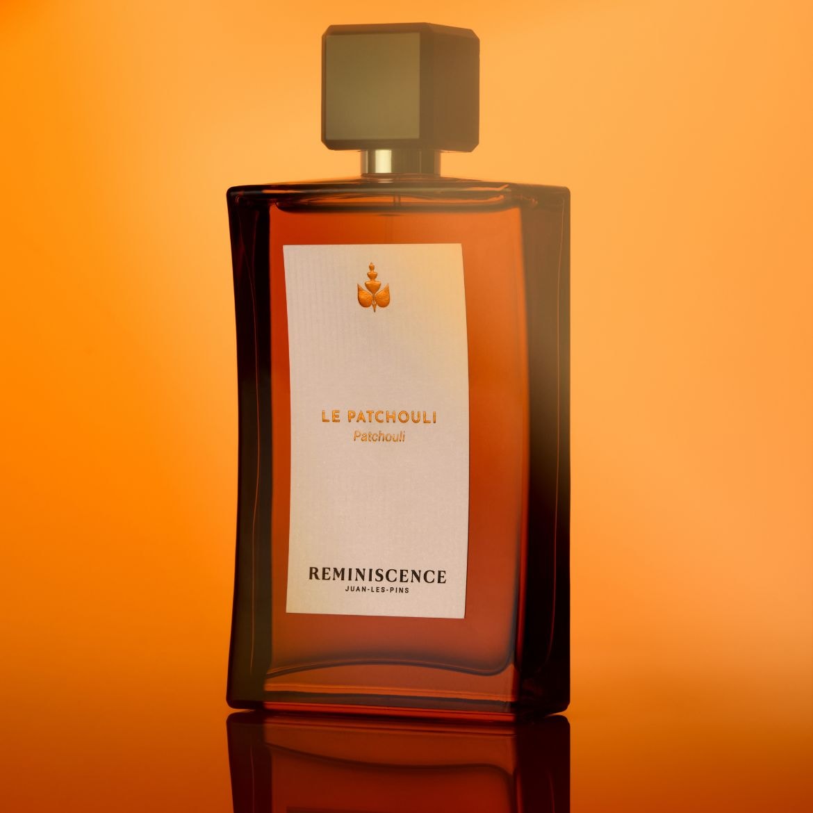 Découvrez le parfum Le Patchouli de Réminiscence, un parfum ambré présenté dans un flacon carré aux tons chauds.