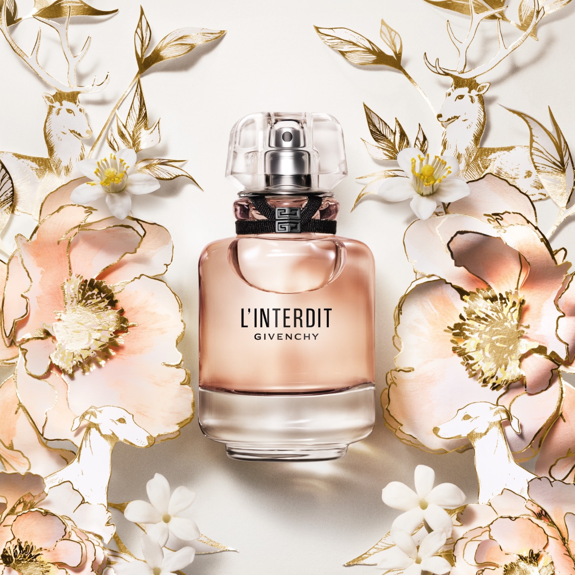 Découvrez L'Interdit de Givenchy, un parfum élégant dans un flacon rose clair, orné de fleurs délicates et de motifs dorés.
