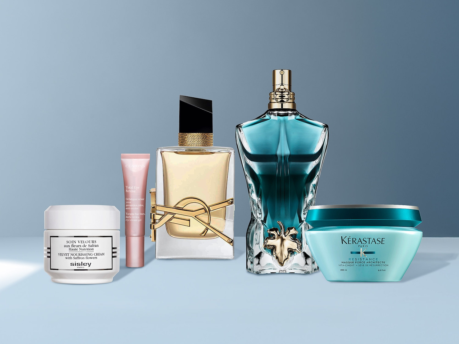 Découvrez une sélection de produits de beauté, comprenant une crème nourrissante Sisley Paris, un soin contour des yeux Clarins, un parfum YSL et un masque capillaire Kérastase, pour une routine de soin complète.